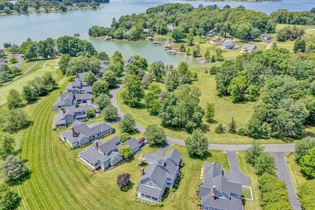 an aerial view of residential house with outdoor space and lake view