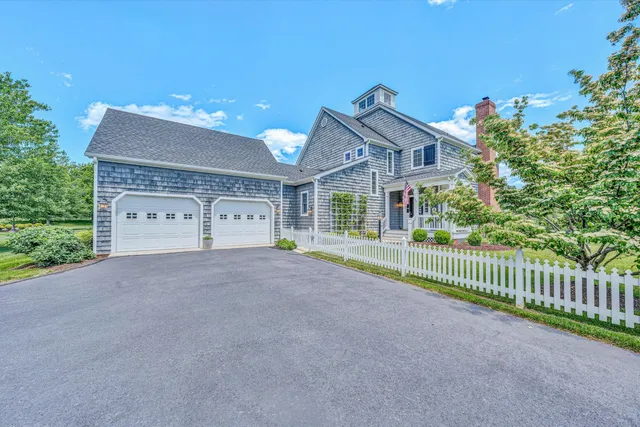 a view of a house with a yard and garage
