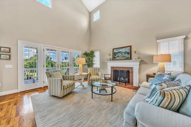 a living room with fireplace furniture and a large window