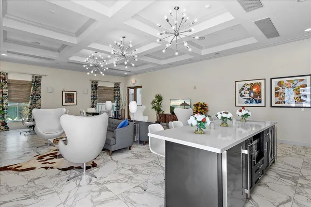 a view of a dining room with furniture and a chandelier fan