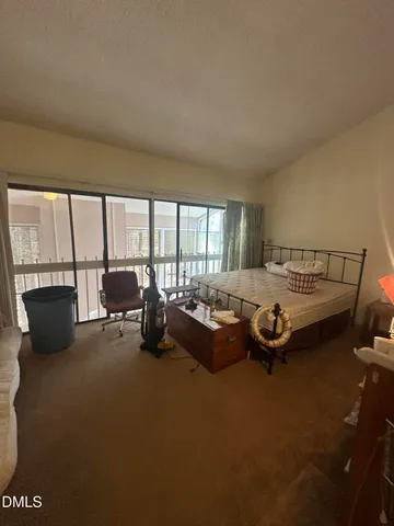 a bedroom with furniture and large windows