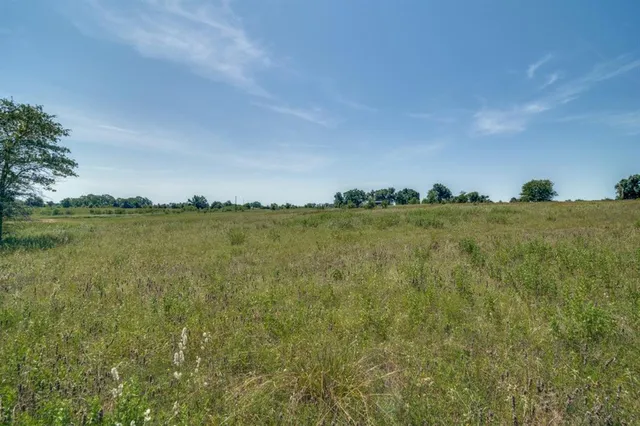 a view of a lake with houses in the back