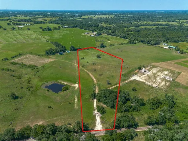 an aerial view of a houses with a yard