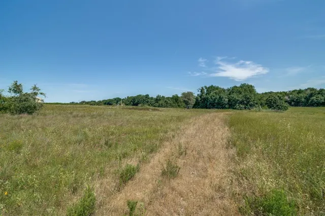 a view of a lake with houses in the back