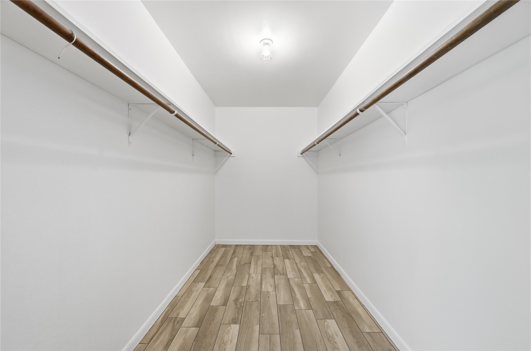 7 Hull Circle Austin, TX 78746 - Photo 8 of 14 Walk in closet featuring wood finish floors