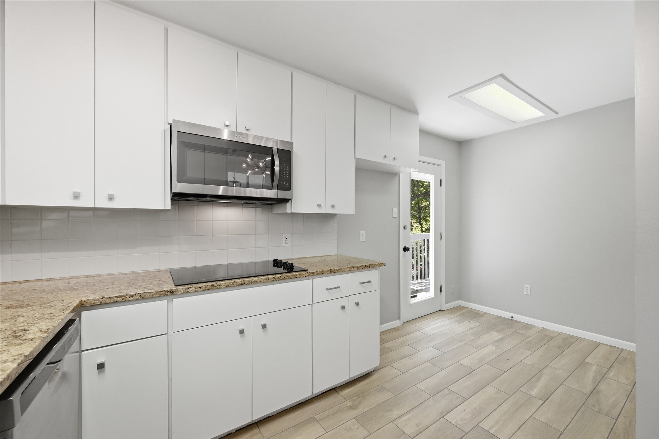 7 Hull Circle Austin, TX 78746 - Photo 10 of 14 Kitchen featuring stainless steel appliances and white cabinets