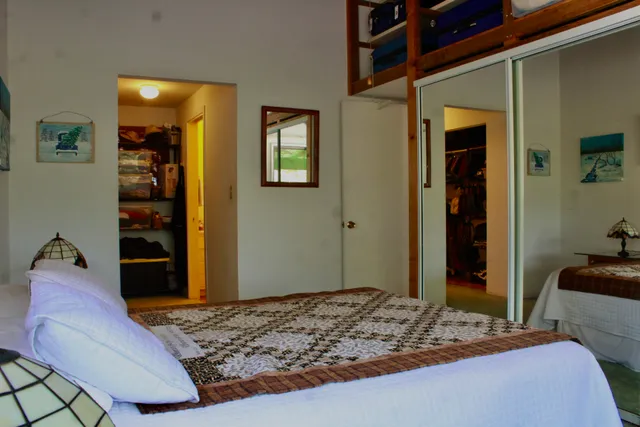 a bedroom with a bed and a dresser