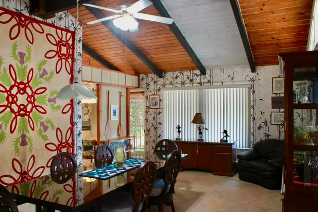 a dining room with furniture and wooden floor