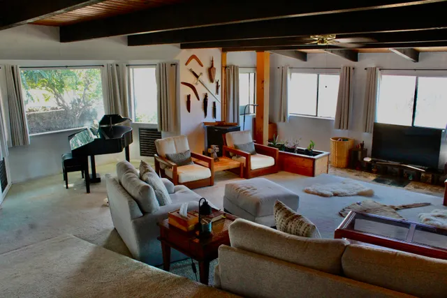 a living room with patio couch and a window