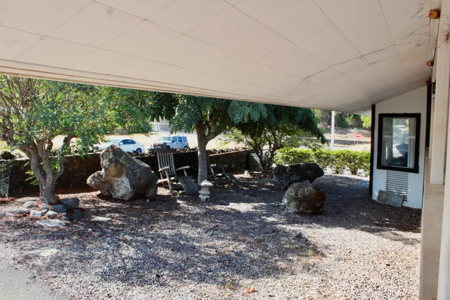 a view of a patio with furniture and garden