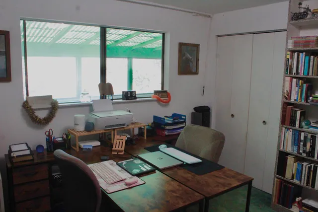 a living room with furniture and a book shelf