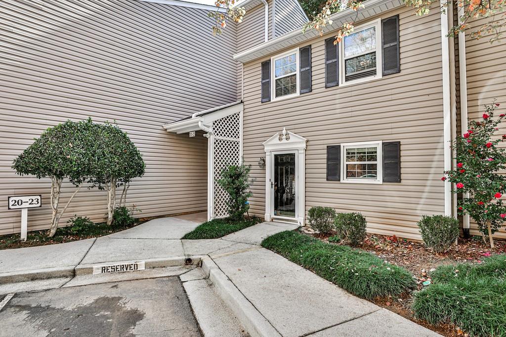 1750 Clairmont Road, Unit 24 Decatur, GA 30033 - Photo 1 of 1 a view of a white house with a yard and potted plants