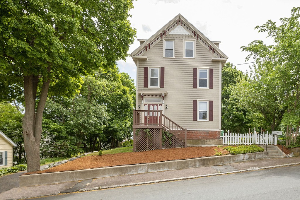 11 Symonds Street, Unit 2 Salem, MA 01970 - Photo 1 of 28 a front view of a house with a yard and garage