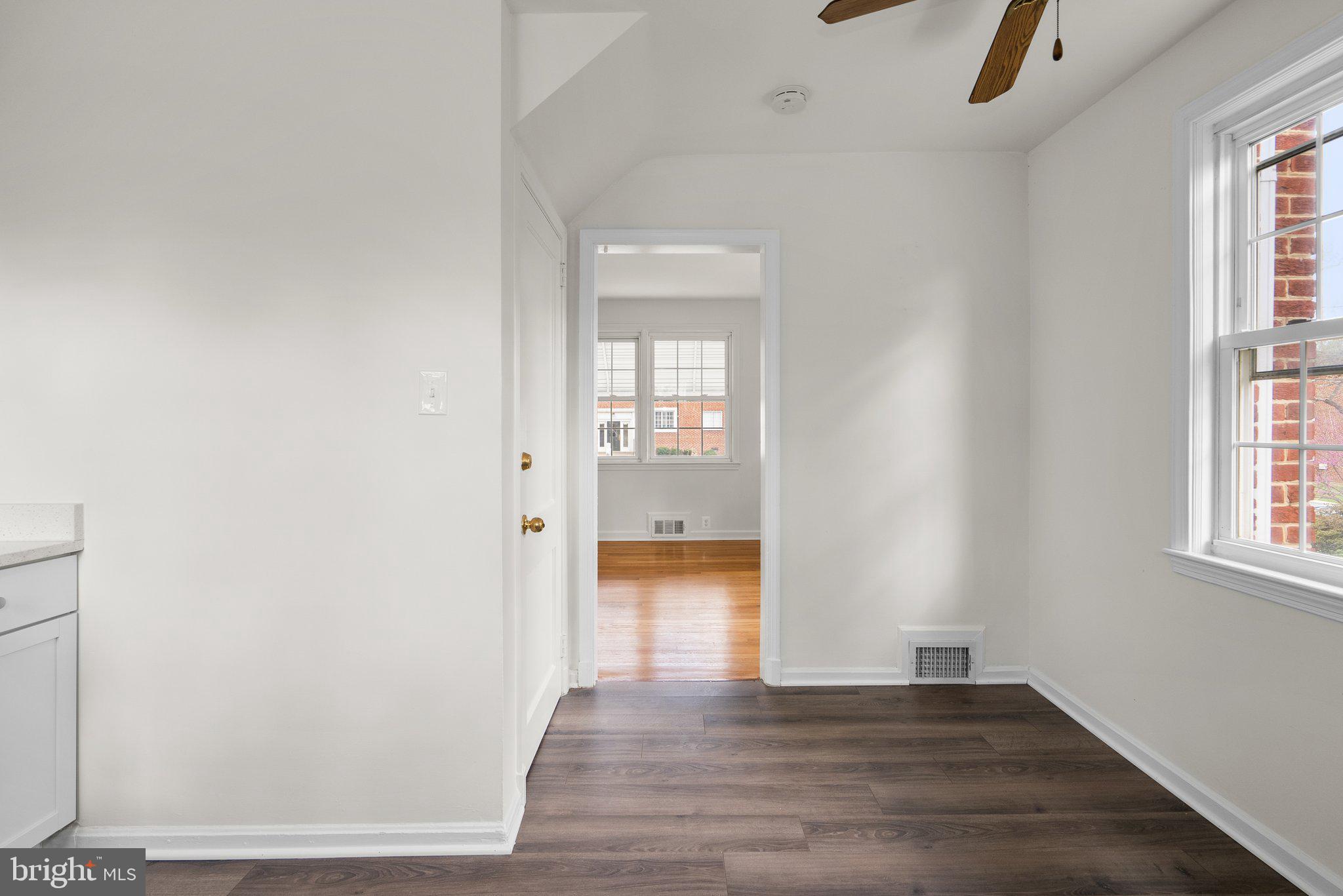 10110 McKenney Avenue Silver Spring, MD 20902 - Photo 16 of 56 an empty room with wooden floor and windows