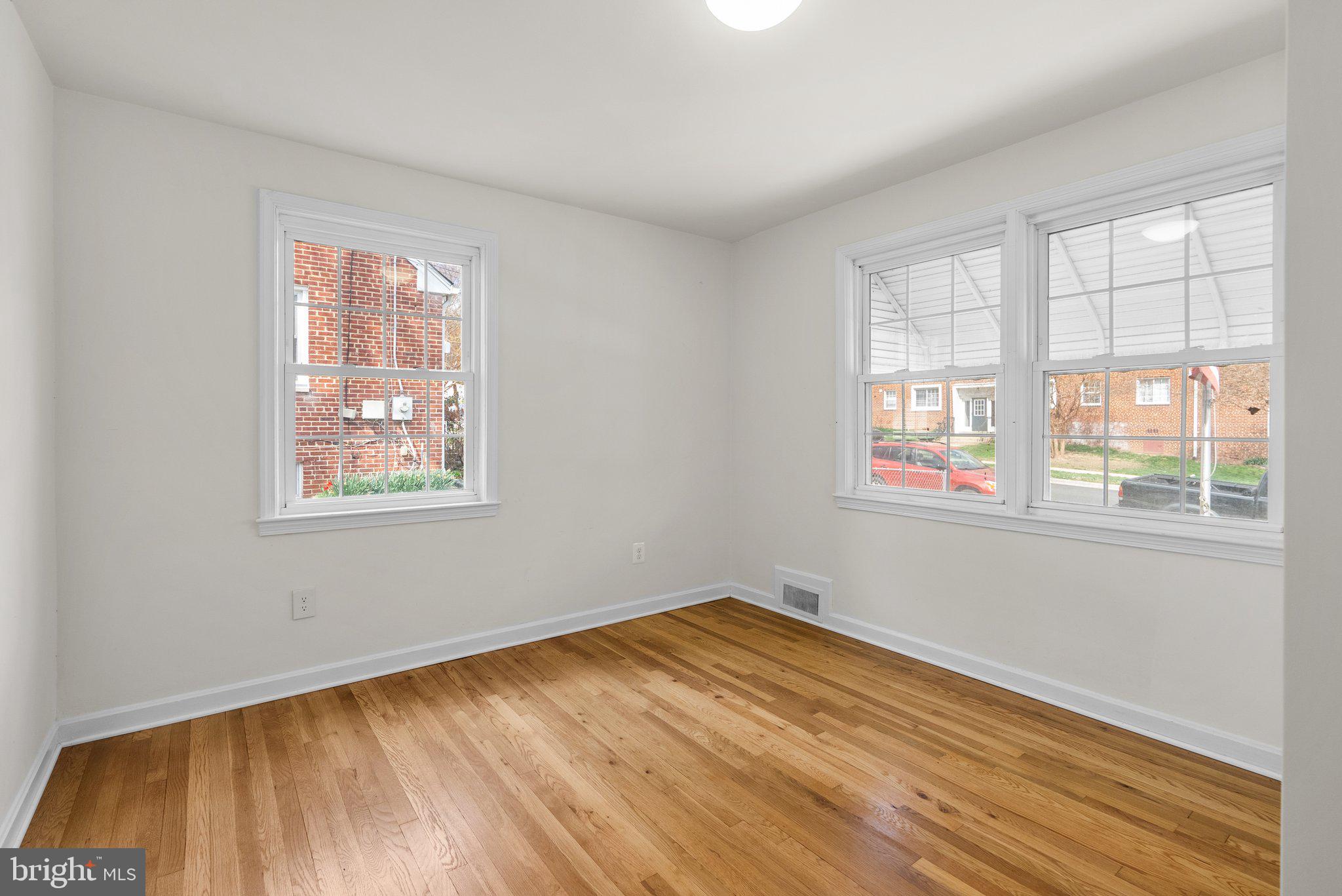 10110 McKenney Avenue Silver Spring, MD 20902 - Photo 18 of 56 a view of empty room with wooden floor and fan