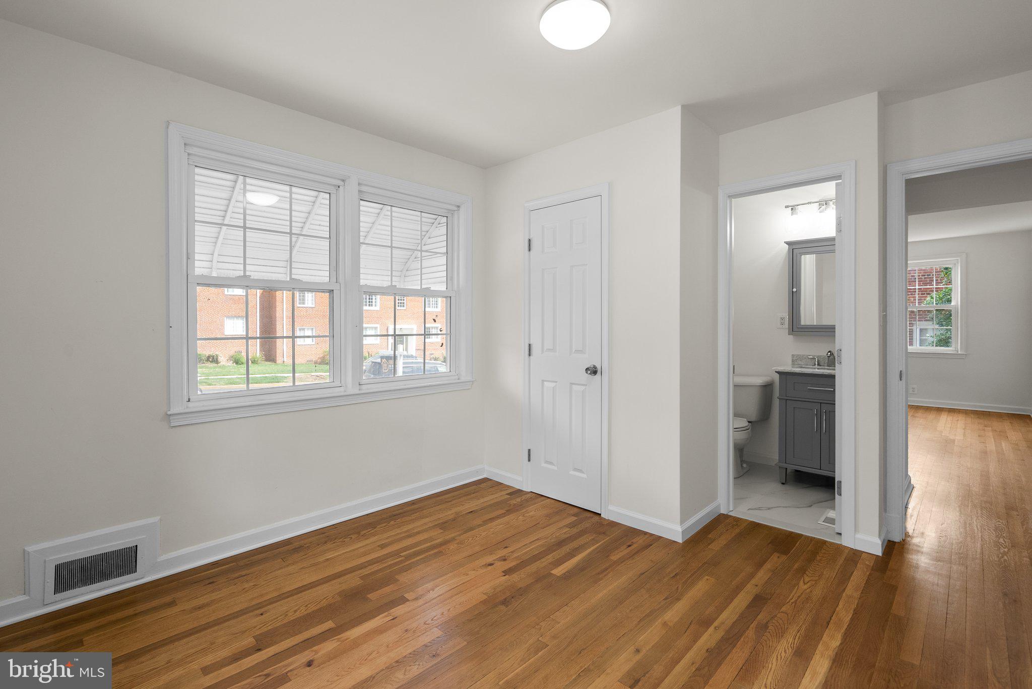 10110 McKenney Avenue Silver Spring, MD 20902 - Photo 19 of 56 wooden floor in an empty room with a window