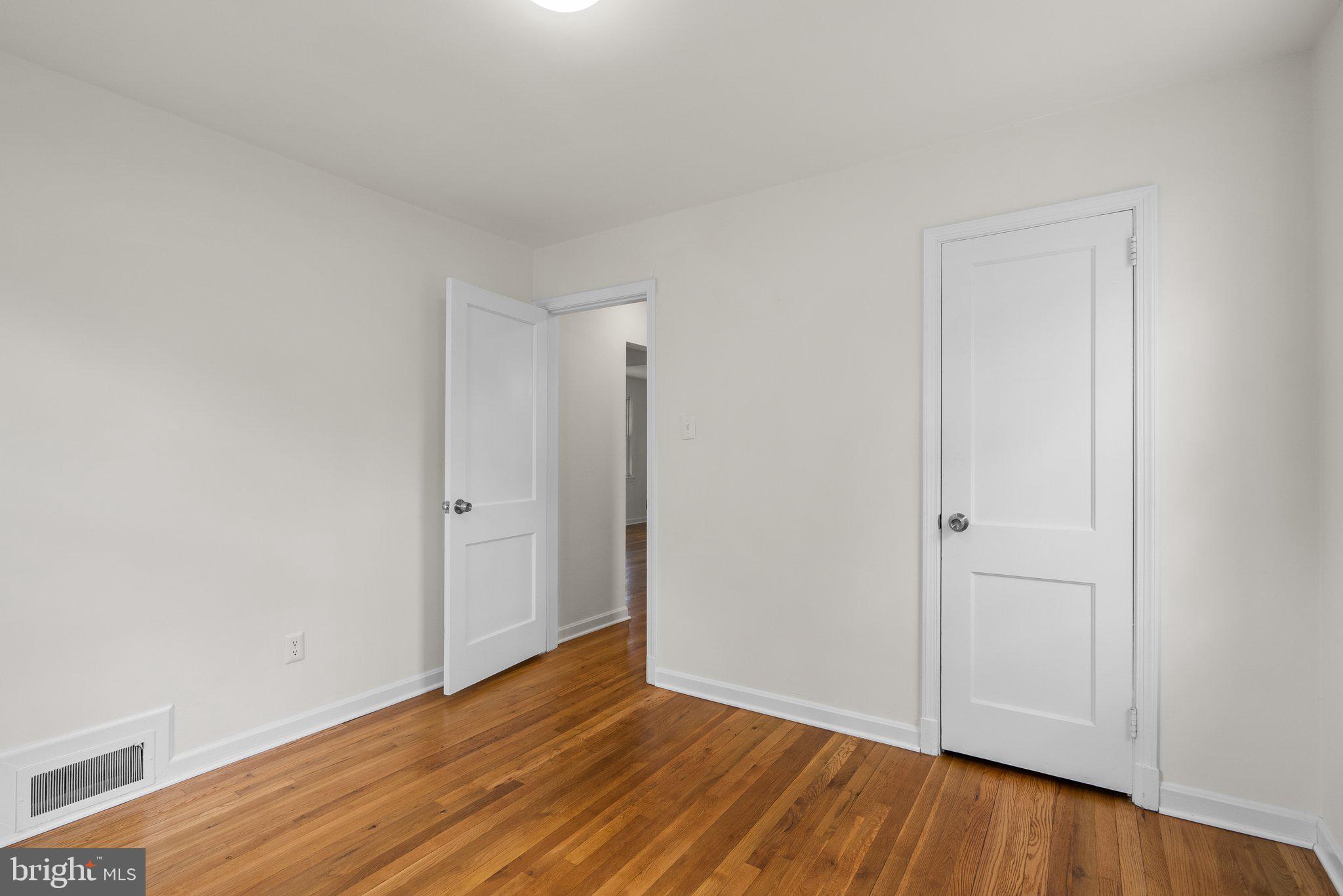 10110 McKenney Avenue Silver Spring, MD 20902 - Photo 27 of 56 a view of an empty room with wooden floor