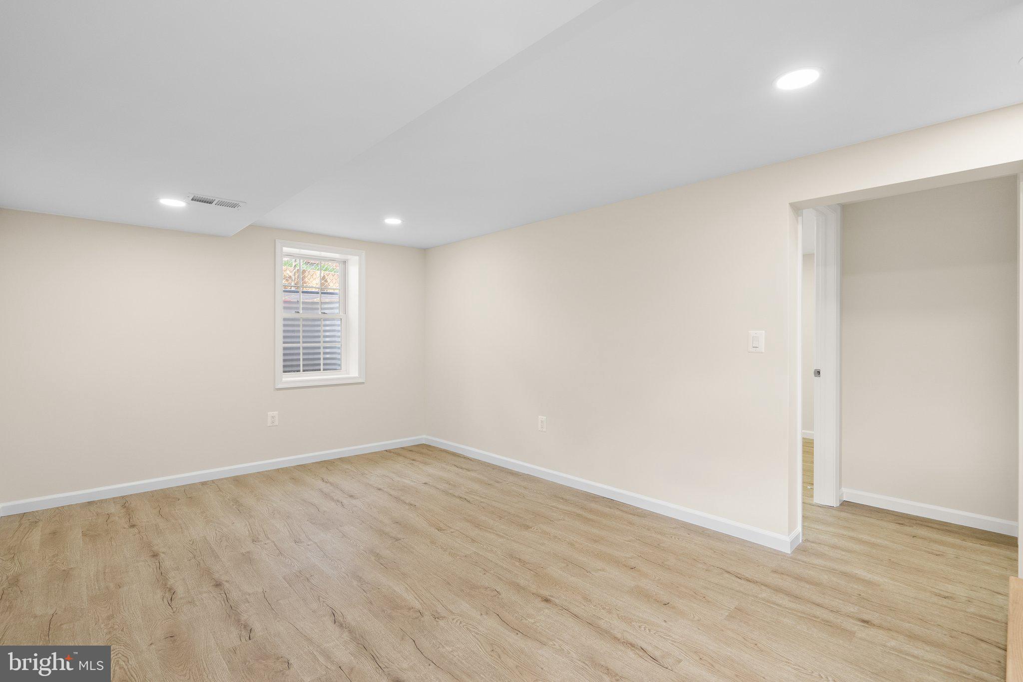 10110 McKenney Avenue Silver Spring, MD 20902 - Photo 40 of 56 an empty room with wooden floor and windows