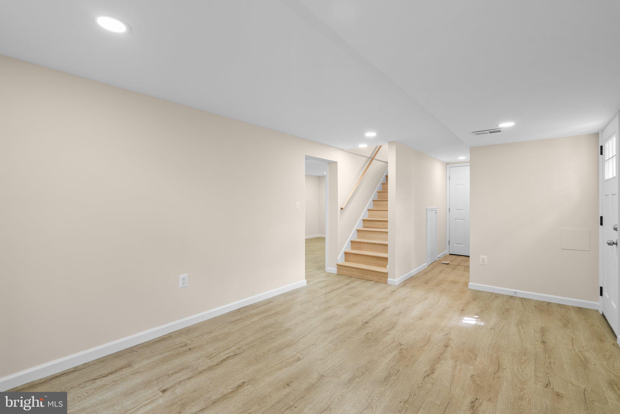 10110 McKenney Avenue Silver Spring, MD 20902 - Photo 41 of 56 a view of an empty room with wooden floor and stairs