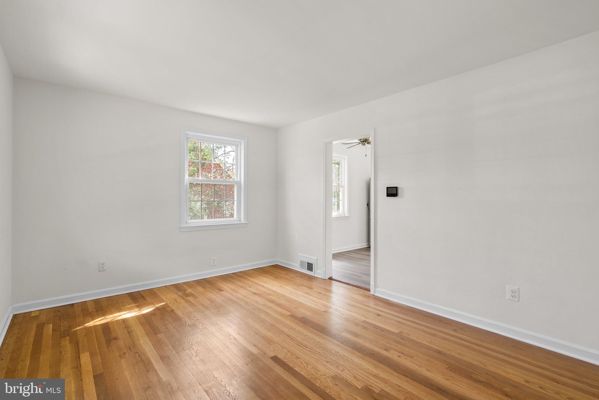 10110 McKenney Avenue Silver Spring, MD 20902 - Photo 5 of 56 a view of empty room with wooden floor and fan