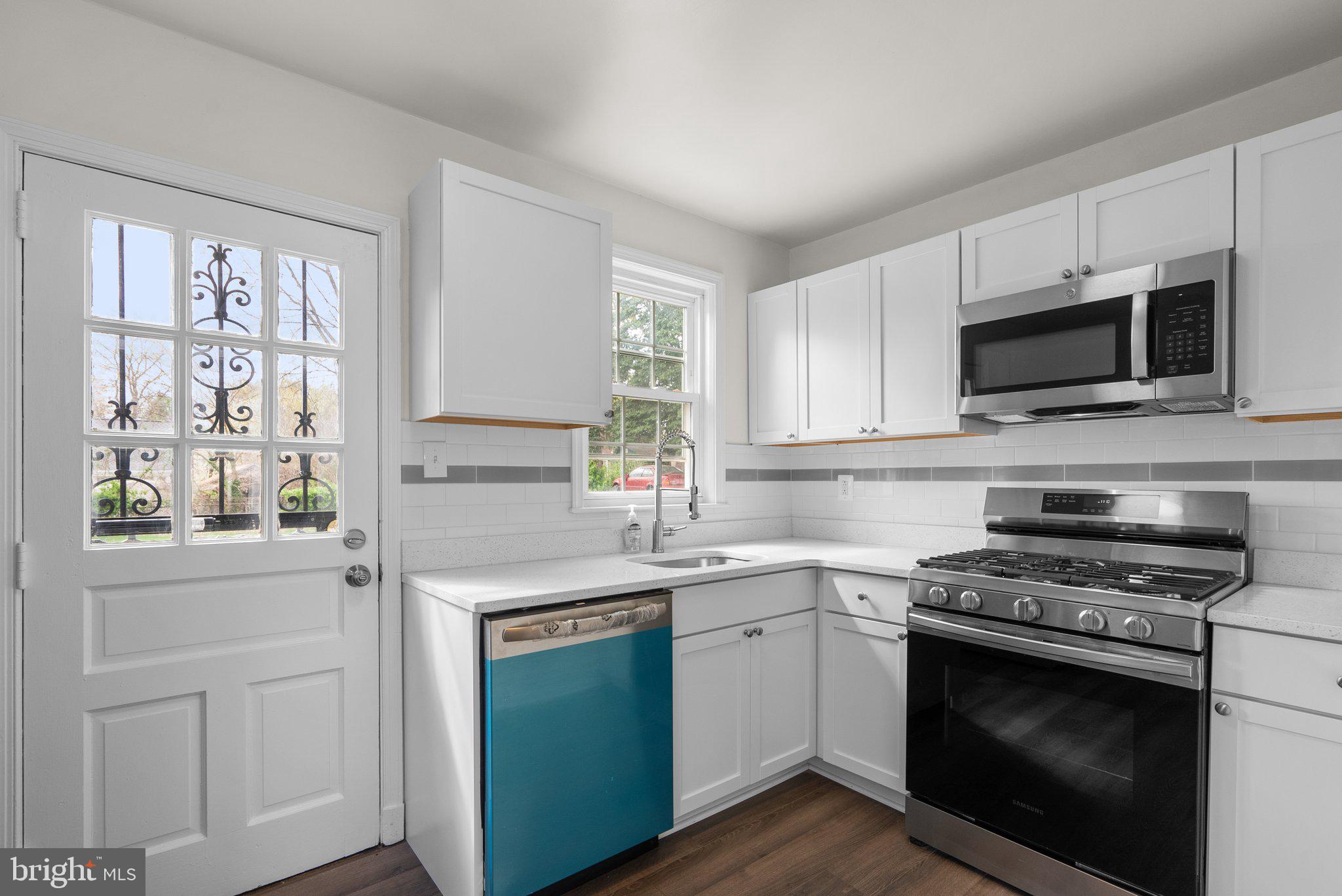 10110 McKenney Avenue Silver Spring, MD 20902 - Photo 10 of 56 a kitchen with cabinets stainless steel appliances a sink and a window
