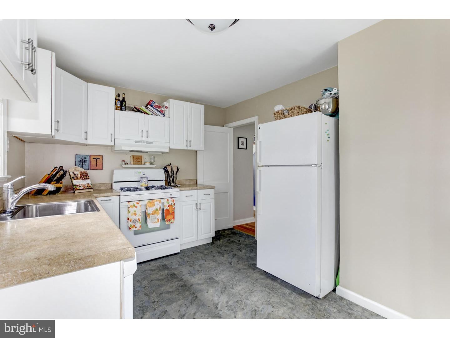 532 Lawrence Road Havertown, PA 19083 - Photo 8 of 22 a kitchen with refrigerator and cabinets
