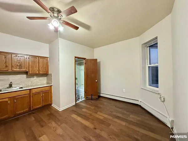 a view of a kitchen with a sink and a cabinet