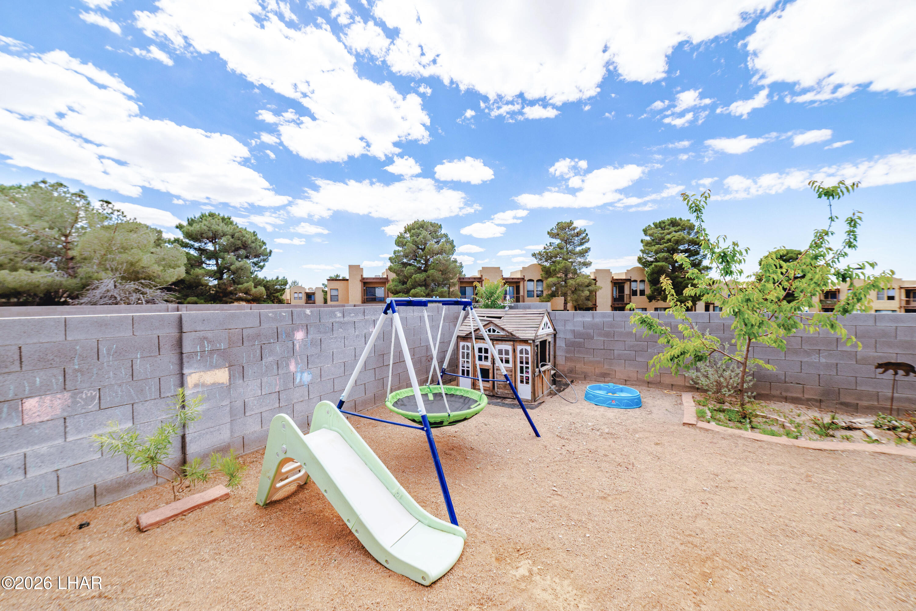 2177 Ridgeview Road Kingman, AZ 86401 - Photo 30 of 43 Expansive backyard featuring a block privacy wall, a small tree, and a large open area