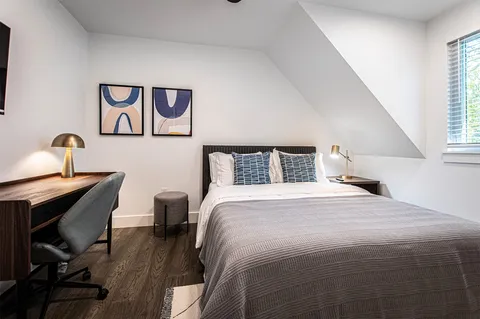 a bedroom with a bed and a window