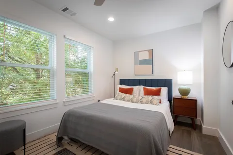 a bathroom with a granite countertop sink a toilet and shower