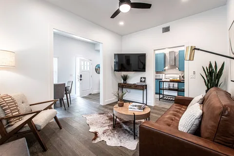 a living room with furniture a window and a chandelier
