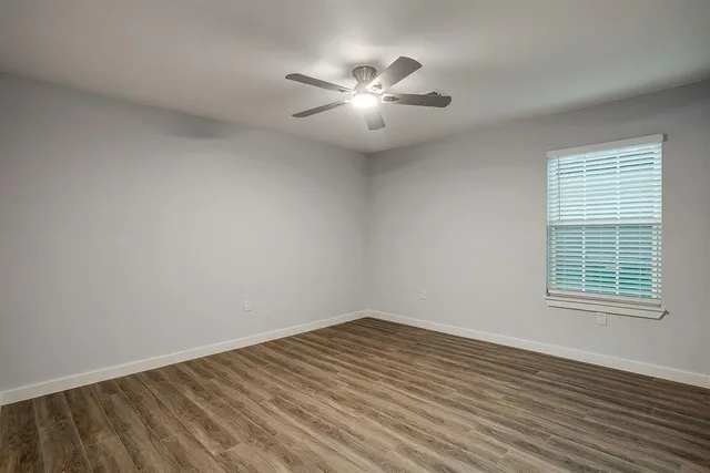 wooden floor in an empty room with a window