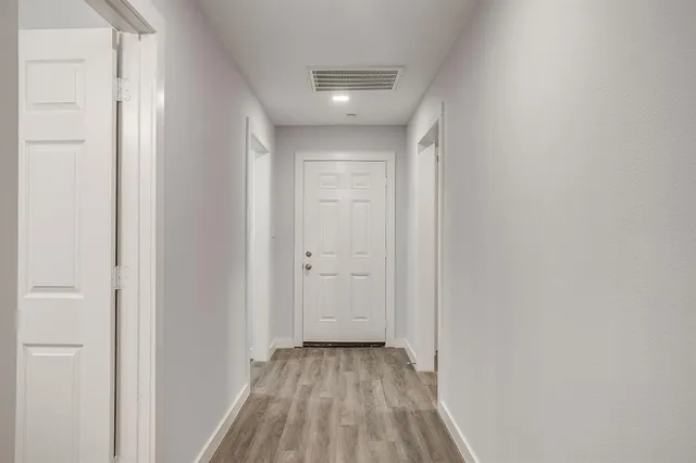 a view of a room with wooden floor
