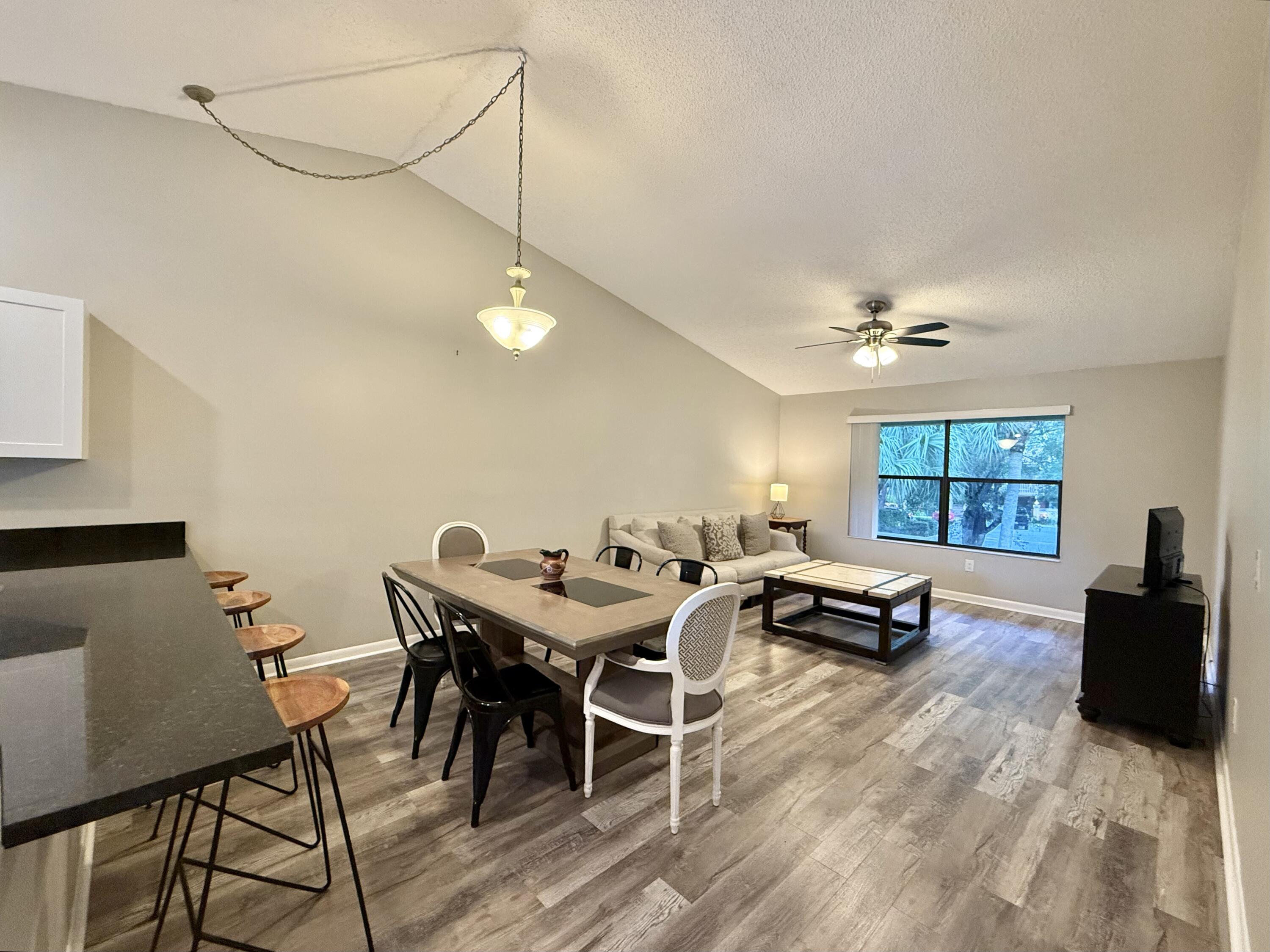 12969 Pennypacker Trail, Unit 15 Wellington, FL 33414 - Photo 1 of 24 a view of a dining room with furniture