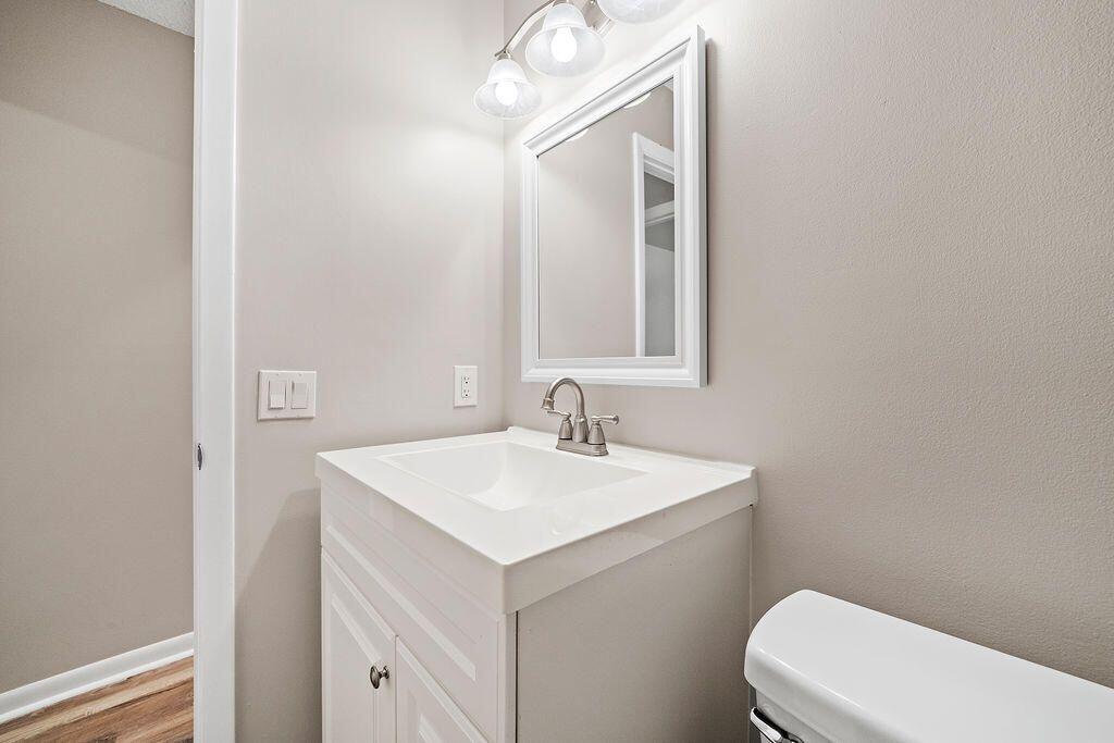 12969 Pennypacker Trail, Unit 15 Wellington, FL 33414 - Photo 10 of 24 a bathroom with a sink a toilet and mirror