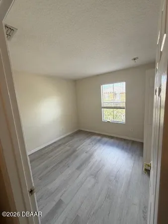 a view of an empty room with a window