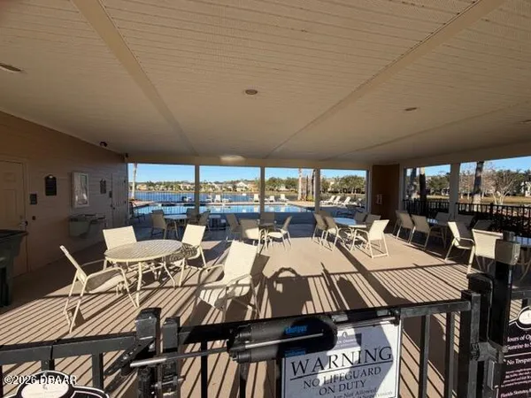 a view of a balcony with wooden floor and a potted plant