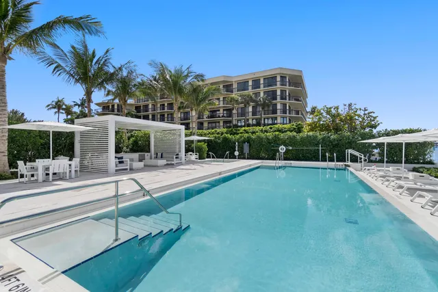 a view of a swimming pool and an outdoor seating
