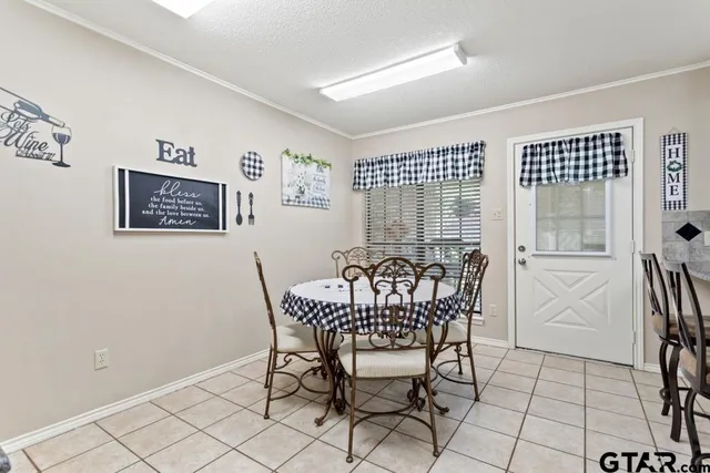 a dining room with furniture and window