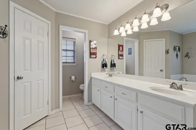 a spacious bathroom with a granite countertop sink a mirror and a shower
