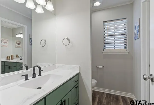 a bathroom with a sink vanity granite and a mirror