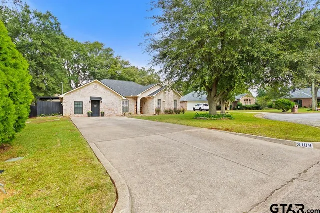 a view of house with yard and green space