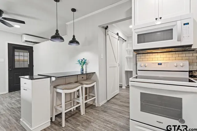 a kitchen with a stove and a microwave