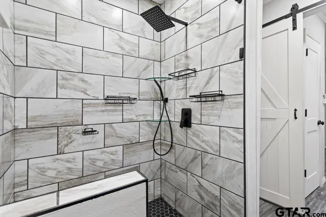 a room with lots of white walls and glass windows