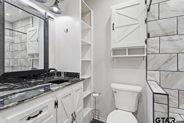 a bathroom with a toilet sink and shower