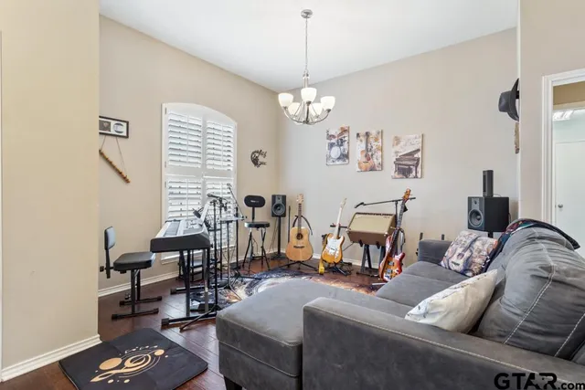 a living room with furniture a couch and a chandelier
