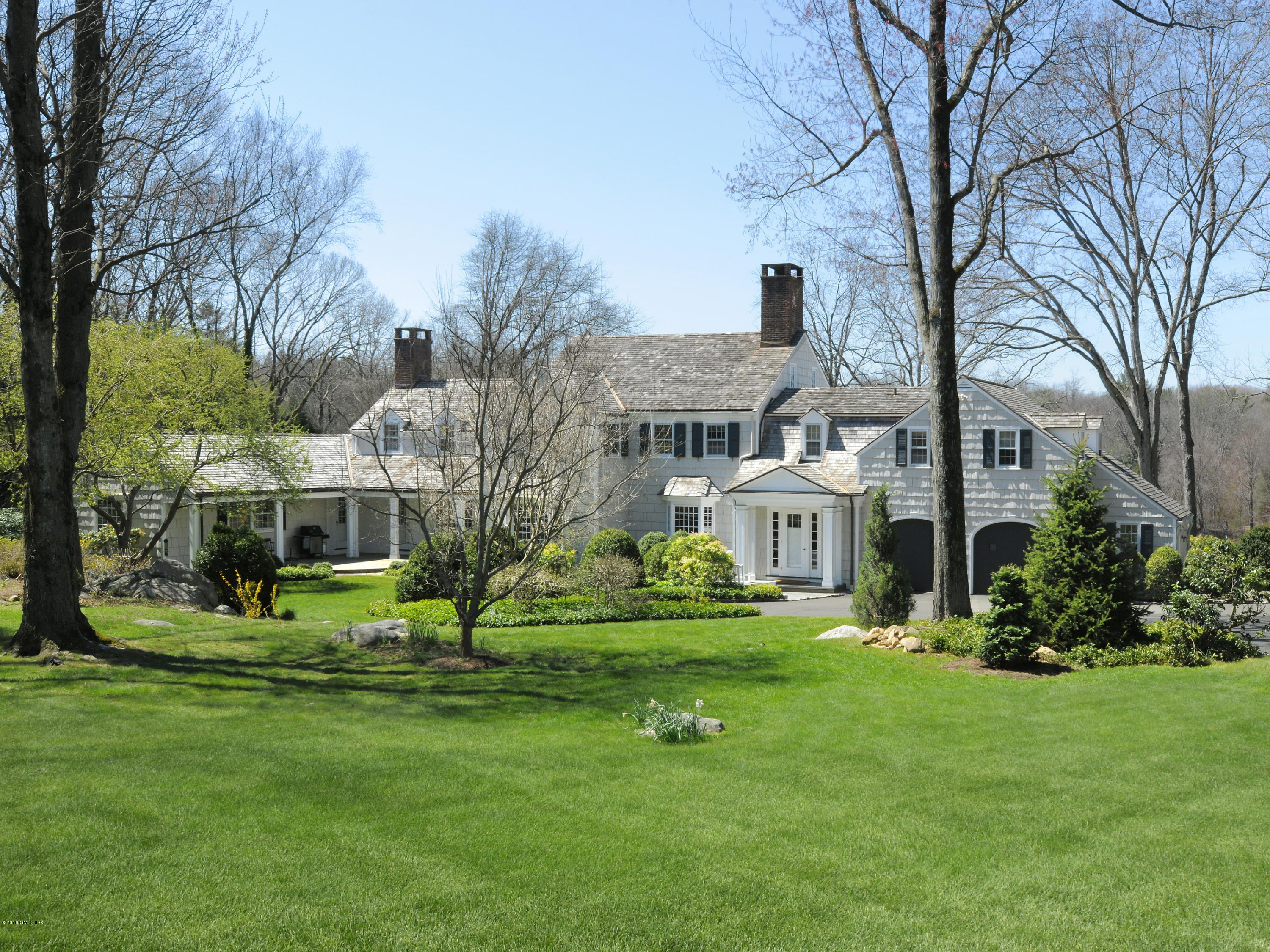 295 Round Hill Road Greenwich, CT 06831 - Photo 12 of 14 a front view of house with a garden and trees