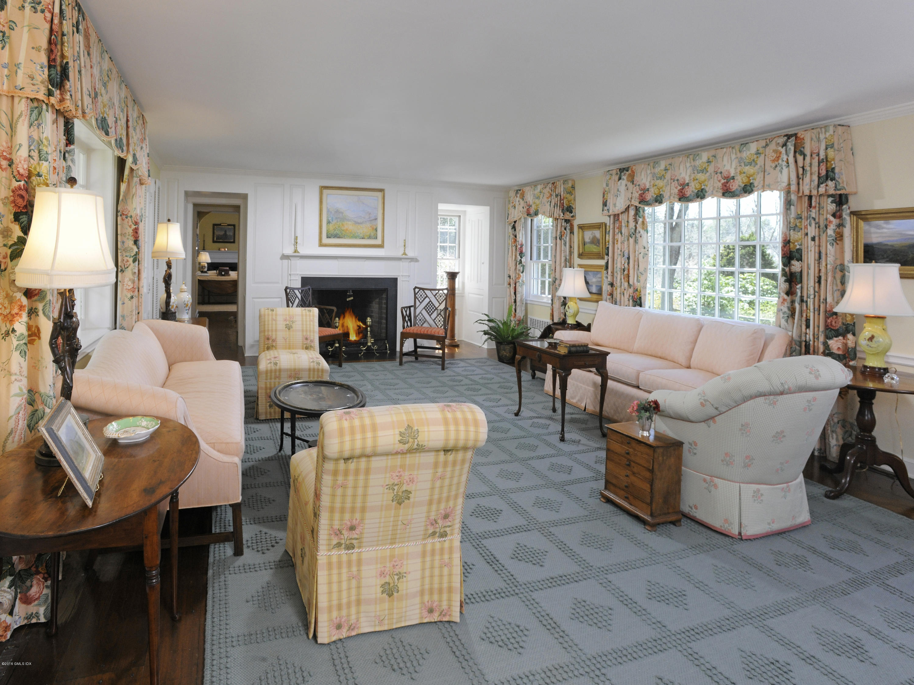 295 Round Hill Road Greenwich, CT 06831 - Photo 4 of 14 a living room with furniture a fireplace and large windows