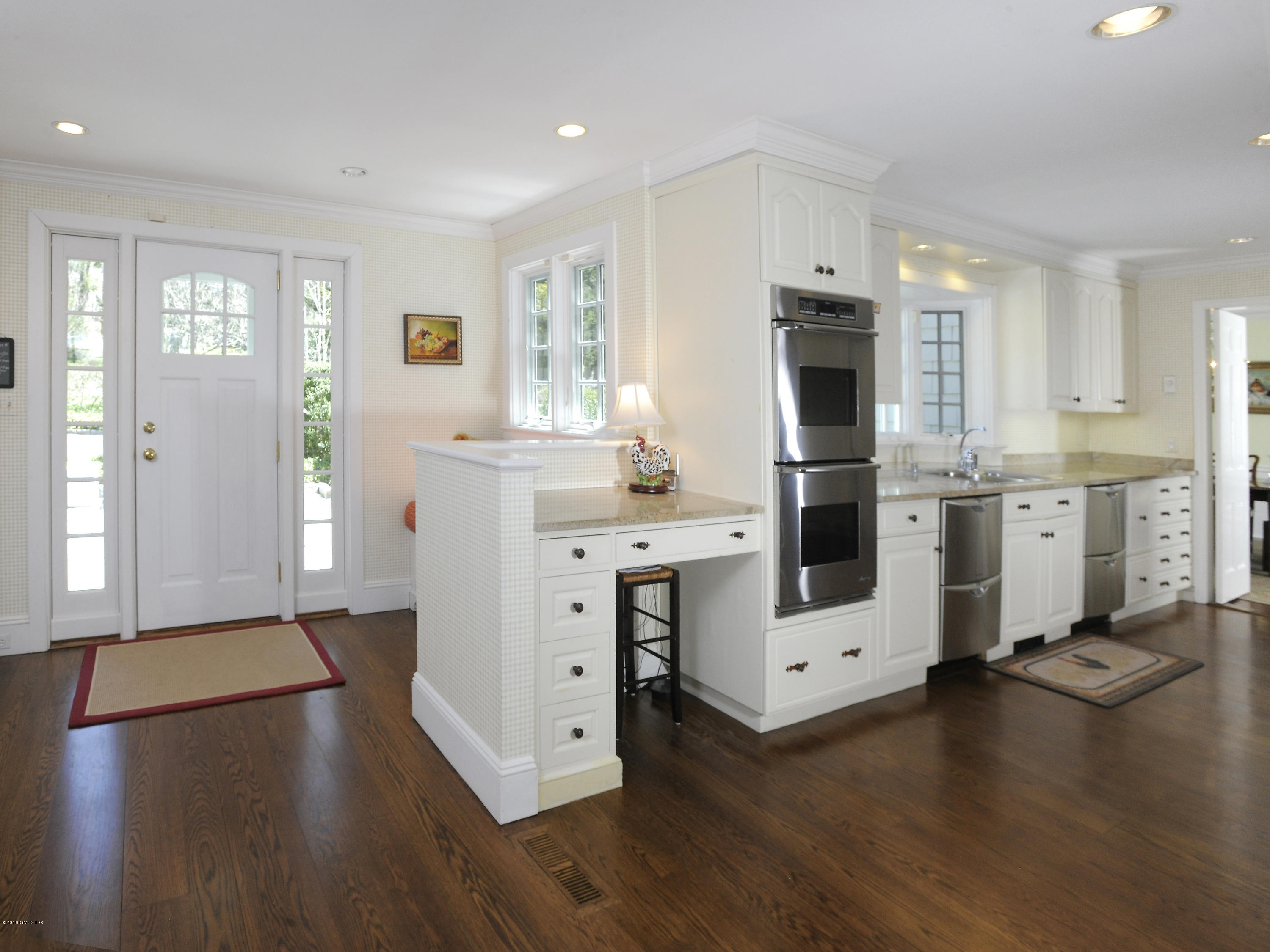 295 Round Hill Road Greenwich, CT 06831 - Photo 9 of 14 a kitchen with stainless steel appliances a stove refrigerator and wooden floor