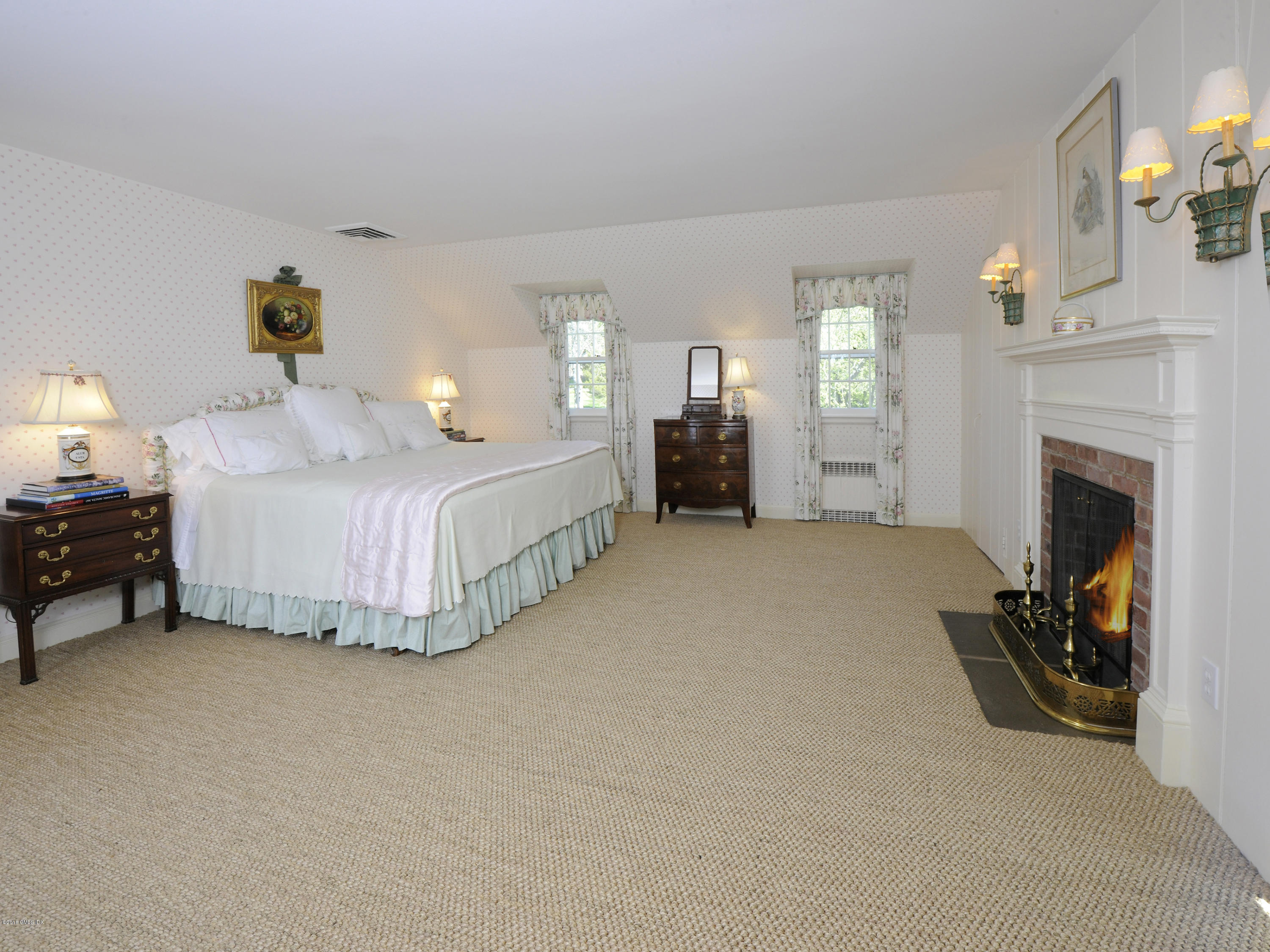 295 Round Hill Road Greenwich, CT 06831 - Photo 10 of 14 a spacious bedroom with a bed and a fireplace